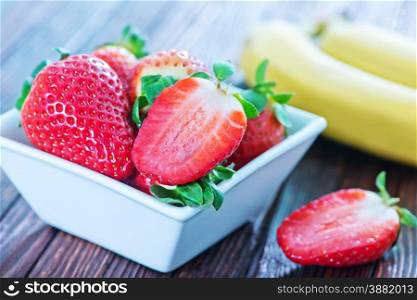 banana and strawberry on the wooden table