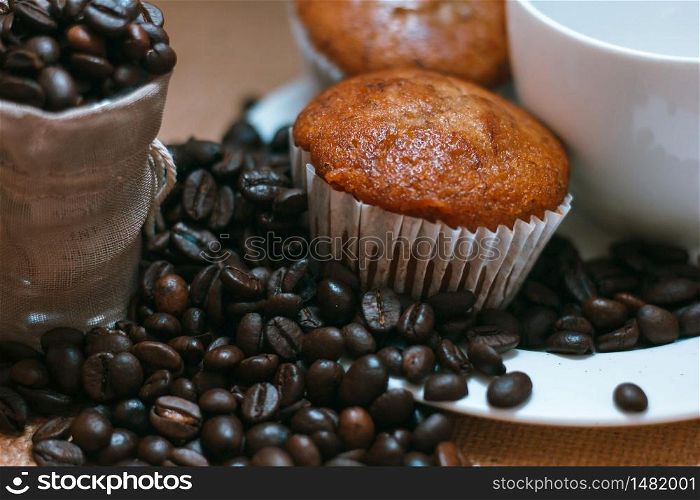 Banana cake placed in a plate And coffee beans on the side