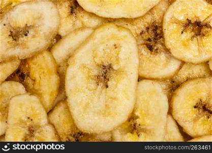 Banana chips, dehydrated slices of fresh ripe bananas as food background. . Banana chips for background