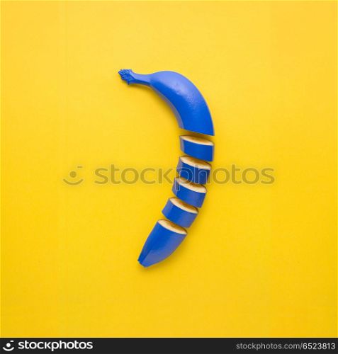 Banana cut.. Creative still life photo of cut blue banana on yellow background.
