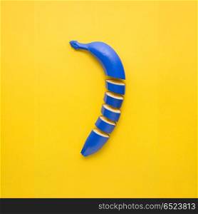 Banana cut.. Creative still life photo of cut blue banana on yellow background.