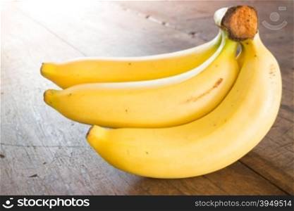 Banana on brown wooden background, stock photo