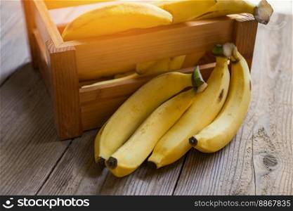 banana on wooden box background, ripe banana fruit on floor - bunch of bananas 