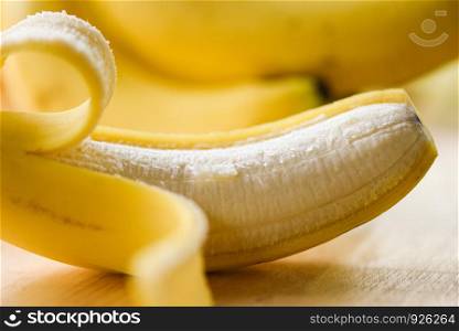 Banana peel / Close up od fresh ripe a banana fruit peeled on wooden board