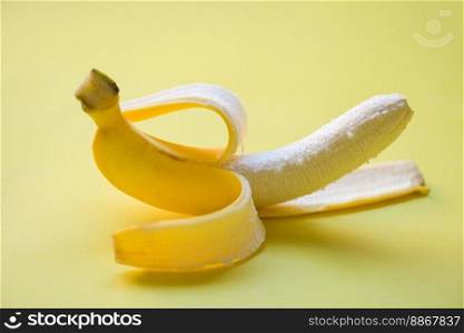 banana peel on yellow background, ripe banana peel fruit on floor