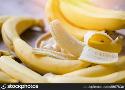 banana peel on yellow background, ripe banana peel fruit on floor - bunch of bananas 