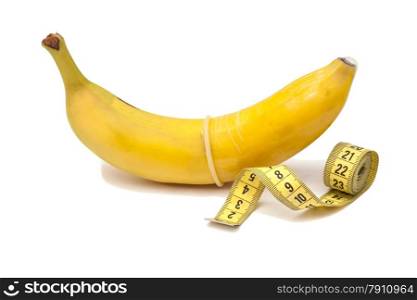 Banana with Condom and measuring tape isolated on white