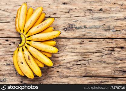 Bananas on an old wooden table.A bunch of ripe bananas.. Bunch of ripe yellow bananas