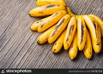 Bananas on an old wooden table.A bunch of ripe bananas.. Bunch of ripe yellow bananas
