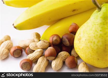 bananas, pears and nuts on white background