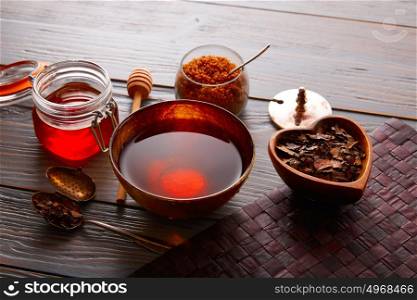 Bancha tea served in golden bowl on wooden table board