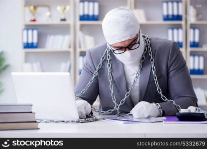 Bandaged businessman worker working in the office doing paperwor. Bandaged businessman worker working in the office doing paperwork