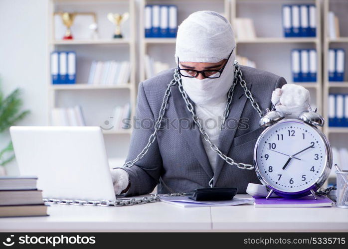 Bandaged businessman worker working in the office doing paperwor. Bandaged businessman worker working in the office doing paperwork