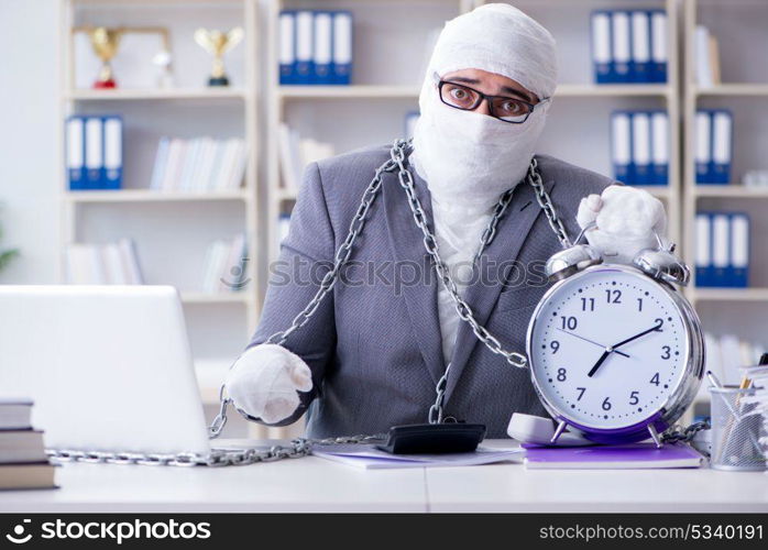 Bandaged businessman worker working in the office doing paperwor. Bandaged businessman worker working in the office doing paperwork