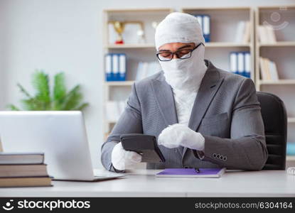 Bandaged businessman worker working in the office doing paperwor. Bandaged businessman worker working in the office doing paperwork