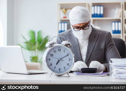 Bandaged businessman worker working in the office doing paperwor. Bandaged businessman worker working in the office doing paperwork