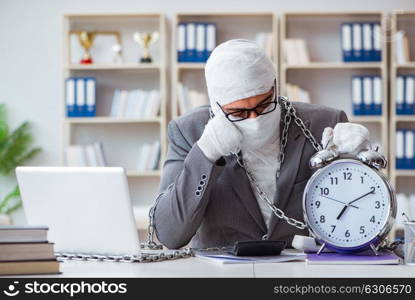 Bandaged businessman worker working in the office doing paperwor. Bandaged businessman worker working in the office doing paperwork