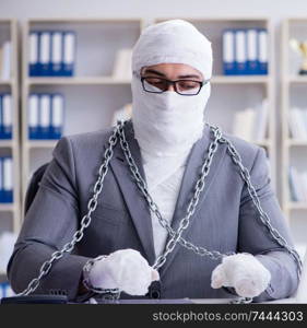 Bandaged businessman worker working in the office doing paperwork. Bandaged businessman worker working in the office doing paperwor