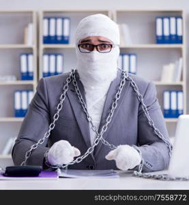 Bandaged businessman worker working in the office doing paperwork. Bandaged businessman worker working in the office doing paperwor