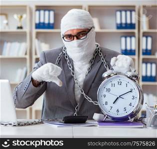 Bandaged businessman worker working in the office doing paperwork. Bandaged businessman worker working in the office doing paperwor