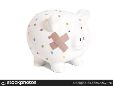 Bandaged piggy bank isolated on white