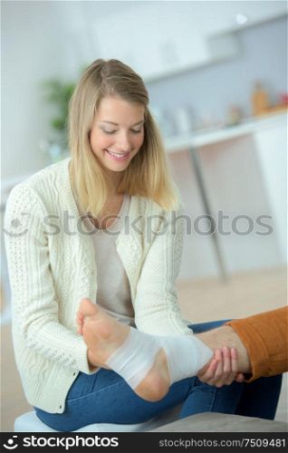 Bandaging her friend's leg