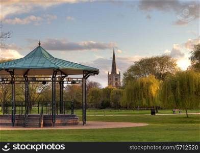 Bandstand and church at Stratford upon Avon, Warwickshire, England.