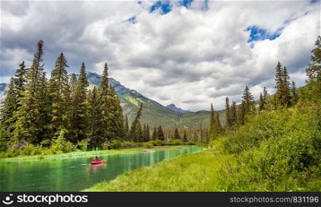 Banff National Park, Alberta, Canada 06.28.2018 Canoe on the Bow River. Canoe at the Bow River in Banff National Park Alberta Canada