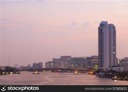 Bangkok city evening Bridges and buildings along the river.
