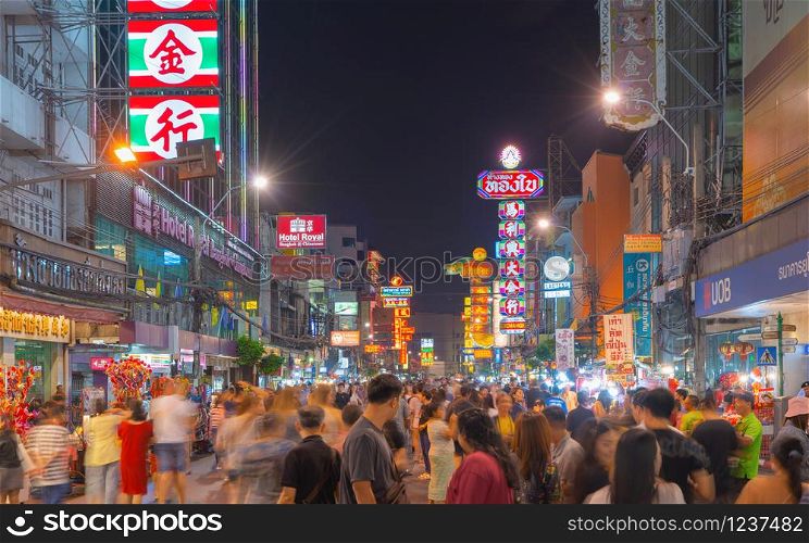 Bangkok City, Thailand - 02/02/ 2020: Night market street at Yaowarat road, the famous tourist attraction with full of advertising Chinese signs. Crowd of tourists people with billboard. China town.