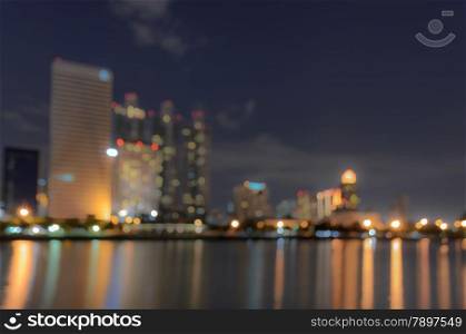 Bangkok skyline at night with reflection on water - Blurred bokeh background