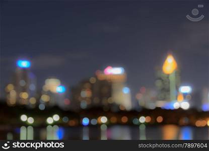 Bangkok skyline at night with reflection on water - Blurred bokeh background