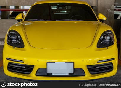 Bangkok, Thailand - 06 Jan 2021   In front of yellow Porsche Sports Car parked in the parking lot. Selective focus.