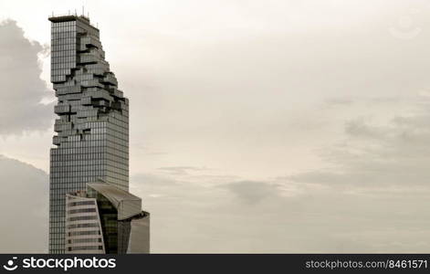 Bangkok, Thailand - 08 Jul 2022   Architectural view of Angular geometric mirror cladding on a modern building with repeating structure and sky and clouds at sunset. Space for text, No focus, specifically.