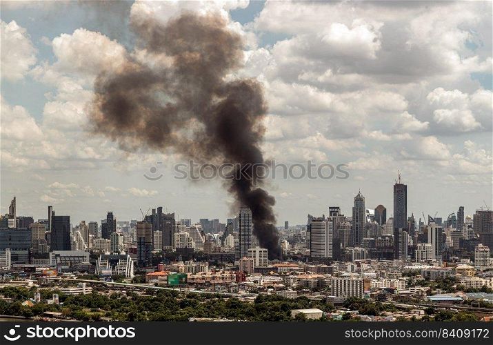 Bangkok, Thailand - 21 Jun, 2022   Plume of black smoke clouds from burnt building on fire at community area in the bangkok city. Fire disaster accident, No focus, specifically.