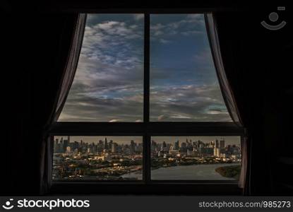 Bangkok, Thailand - 27 Aug, 2019 : The beautiful view of Bangkok, the beautiful skyscrapers along the Chao Phraya River in the evening seen through a bedroom window.