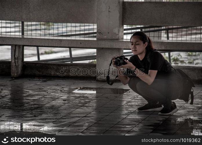Bangkok, Thailand 27 Sep,2019 : Photographer Young woman traveler taking photo Old ferry Landing by camera, Relax holiday hobby concept.