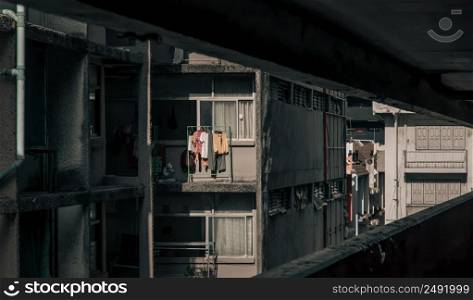 Bangkok, Thailand - Apr 22, 2022 : Panorama of Old apartment with Iron clothes rack for Hanging drying clothes washed outside the windows at rooms. Selective focus.