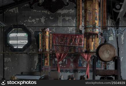 Bangkok, Thailand - Apr 29, 2022 : Architecture interior of Traditional chinese shrine with Traditional Chinese drum and Octagon louver vent on old wall at Phutthamonthon sathan or Sun wukong shrine. Selective focus.