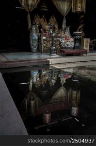 Bangkok, Thailand - Apr 29, 2022 : Reflection on water of Chinese god statues on Chinese altar table at Phutthamonthon sathan or Sun wukong shrine. Selective focus on water reflection.