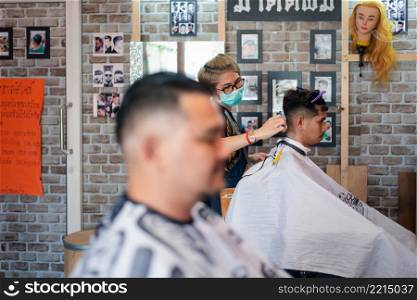 Bangkok, Thailand - April 25, 2017 : Unidentified asian man hairdresser or hairstyle haircut a man plump body customer in fashion hairstyle at barbershop. Hairstyle or barber haircut customer at barbershop