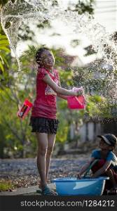 BANGKOK THAILAND - APRIL14,2018 : unidentified thai girl playing songkarn with splashing water and happiness emotion on songkarn day