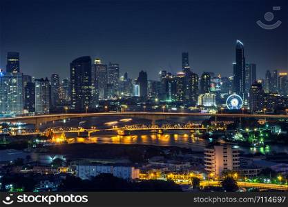 Bangkok thailand cityscape at night many tower near river
