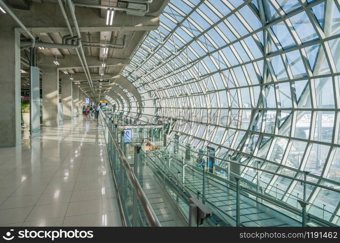 BANGKOK, THAILAND - DEC 11, 2018: Tourists walk in terminal of Suvarnabhumi Airport in Bangkok, Thailand. Suvarnabhumi Airport is one of two international airports serving Bangkok.