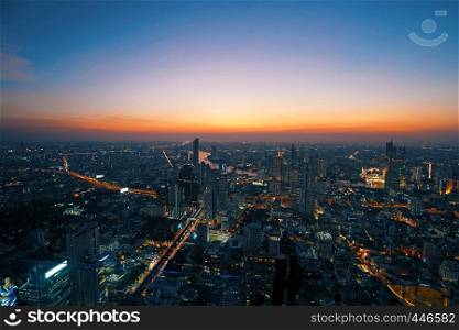 Bangkok, Thailand - December 3, 2018: Beautiful cityscape with sunset and twilight night aerial view of Bangkok. Taking from Mahanakhon Tower Famous skyscrapers of Bangkok.