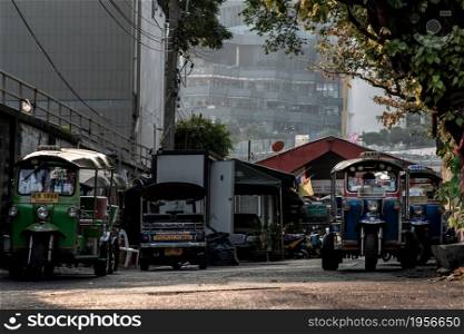 Bangkok, Thailand - Feb 02, 2020 : Famous blue Tuk Tuk, The front of thai traditional taxi parked in an alley.