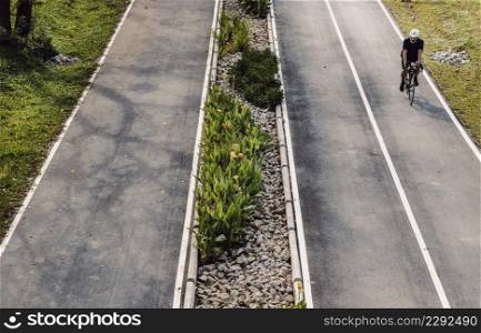 Bangkok, Thailand - Feb 19, 2022 : The cyclist riding a mountain bike an road along in a city park. One man bicycling along on the road, Selective focus.