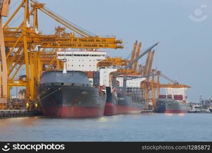 BANGKOK THAILAND - JUNE 27,2013 : large ship loading container box at klong tuey port in heart of bangkok ,chao praya river main of capital vessel import -export and transportation industry product