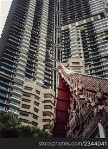 Bangkok, Thailand. Mar - 12, 2022 : View of Buddhist thai temple with Modern tall condominium building in the background can coexist perfectly. Selective Focus.