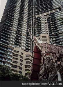 Bangkok, Thailand. Mar - 12, 2022 : View of Buddhist thai temple with Modern tall condominium building in the background can coexist perfectly. No focus, specifically.